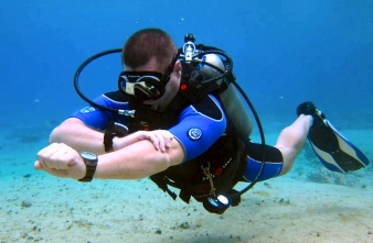 Scuba diver using a compass to navigate underwater