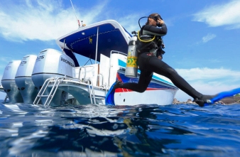 Diver entering the water from a boat with giant stride technique